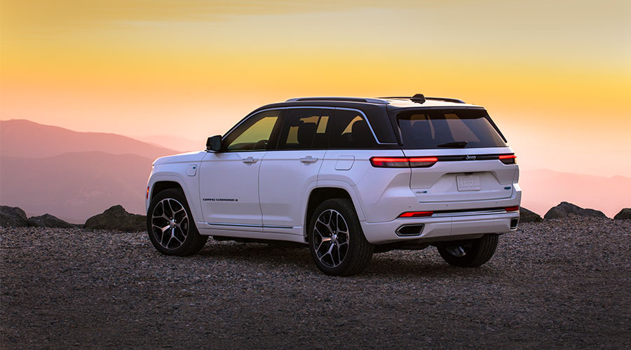 Grand Cherokee driving along highway at sunset