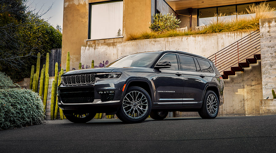 Black Grand Cherokee parked oustide of house