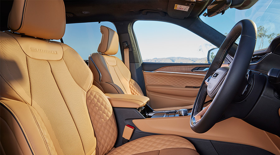 Black Grand Cherokee parked oustide of house