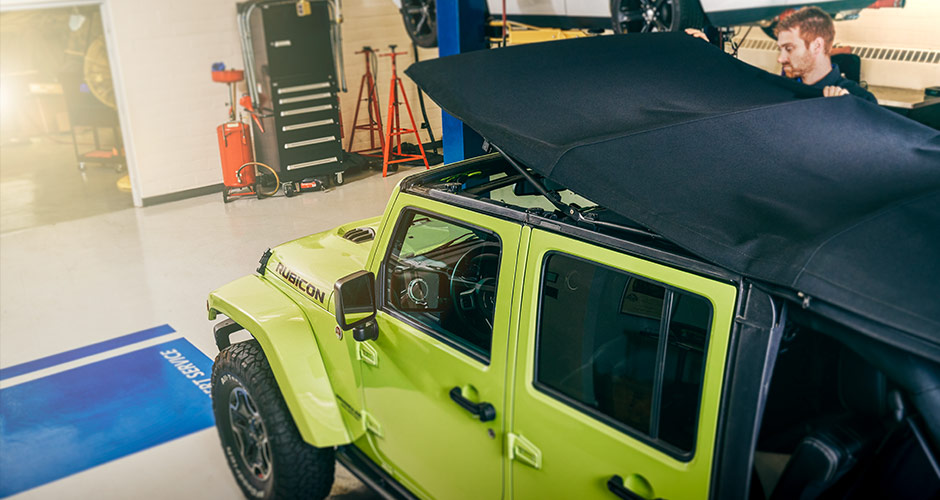 Jeep Wrangler off-roading with paddles boards on top